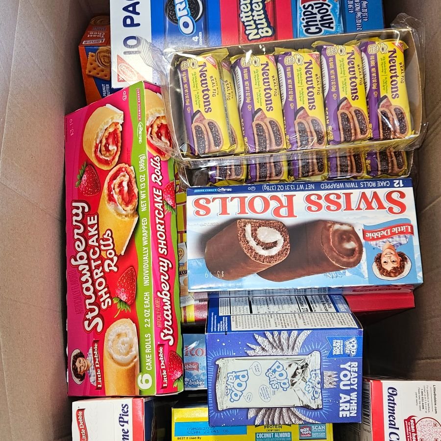 A box of packaged snacks and treats